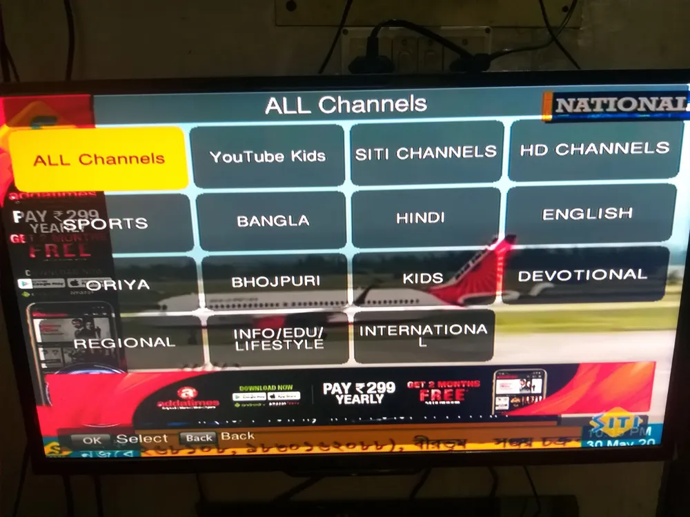 A local cable home screen with tiles for channel groups such as Bangla, Hindi, English, Oriya, Bhojpuri, Kids and Regional