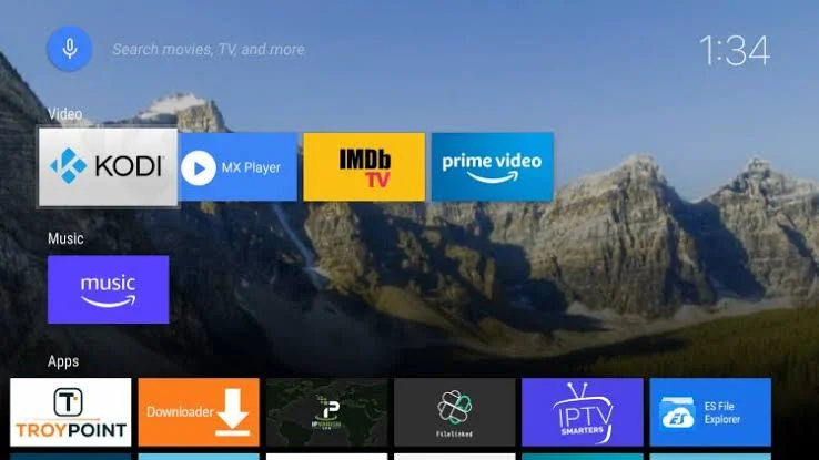 Classic Android TV home screen: rows of app shortcuts grouped under Video, Music and Apps over a mountain wallpaper
